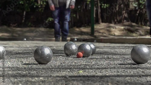 slow motion closeup of petanque balls colliding during play.