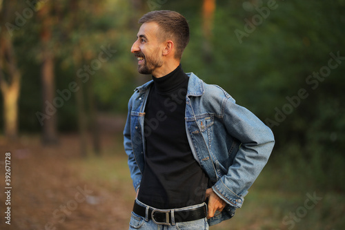 The guy laughs. Happy guy. A man in nature. Guy on a walk in the fall.