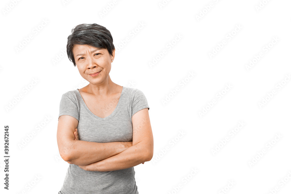 A shy gray-haired Asian woman holding her arms and laughing, felt joy, posing on the white studio background. Positive senior ideas concept A shy gray-haired Asian woman holding her arms and laughing, felt joy, posing on the white studio background. Positive senior ideas concept