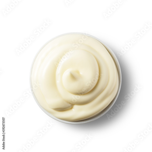 Fresh mayonnaise in a bowl on a white isolated background. Top view.