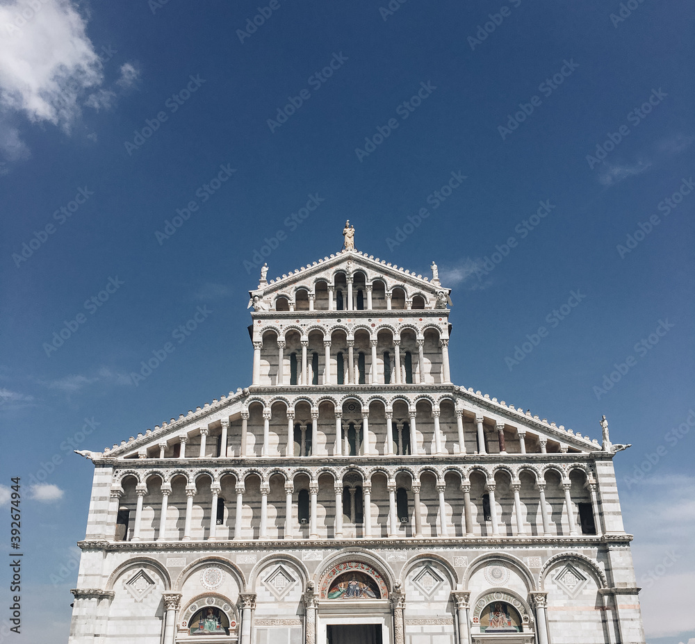 Tourist visiting the leaning tower of Pisa , Italy. Pisa Cathedral and the Leaning Tower in a sunny day in Pisa, Italy.