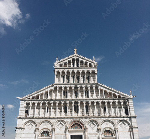 Tourist visiting the leaning tower of Pisa , Italy. Pisa Cathedral and the Leaning Tower in a sunny day in Pisa, Italy.
