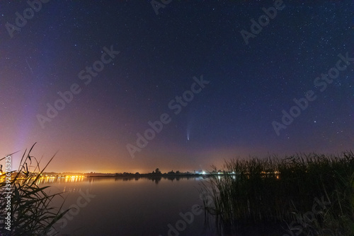 A magical starry night on the river by the Milky Way and a comet in the sky