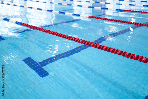 Obraz na plátně fragment of the competition pool with blue water and marked swimming lanes