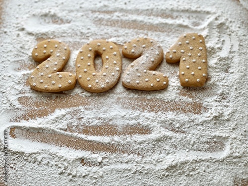 2021 Christmas cookies date on flour background 