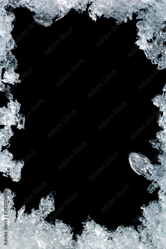 Fototapeta premium Artistic frame made from snow and ice over black background