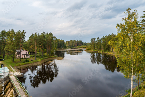 Aerial view of river among the forest. Summer nature landscape. Sunset.