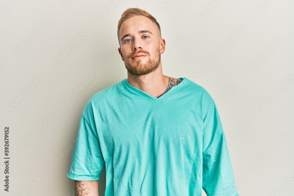 Fototapeta premium Young caucasian man wearing casual clothes relaxed with serious expression on face. simple and natural looking at the camera.