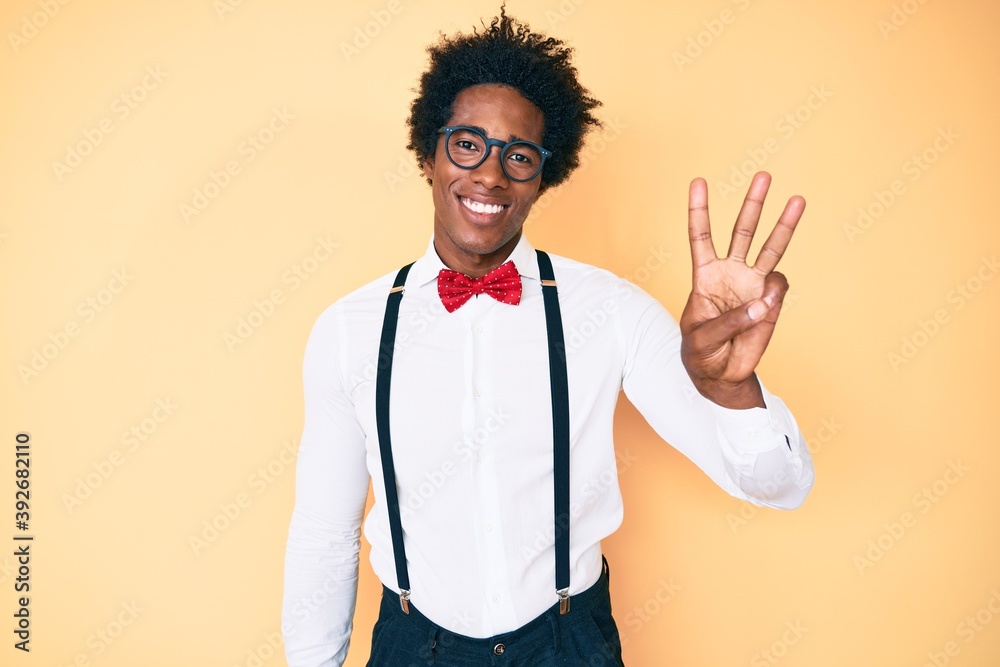 Handsome african american man with afro hair wearing hipster elegant look showing and pointing up with fingers number three while smiling confident and happy. Handsome african american man with afro hair wearing hipster elegant look showing and pointing up with fingers number three while smiling confident and happy.