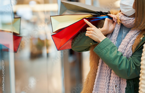 Portrait of two friends shopping together wearing a mask, coronavirus concept