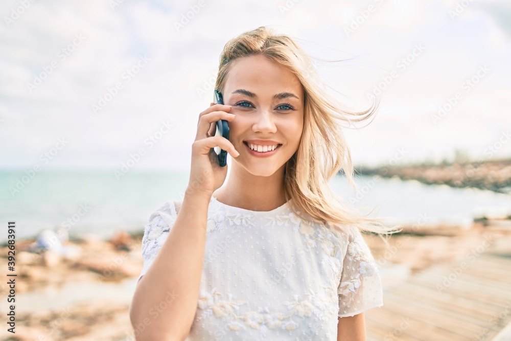 Young caucasian girl smiling happy talking on the smartphone at street of city. Young caucasian girl smiling happy talking on the smartphone at street of city.