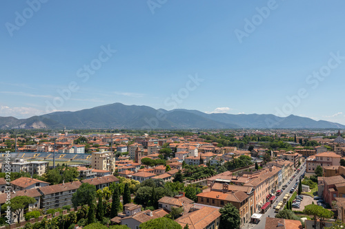 Panoramic view of Pisa city with historic buildings and far away mountains