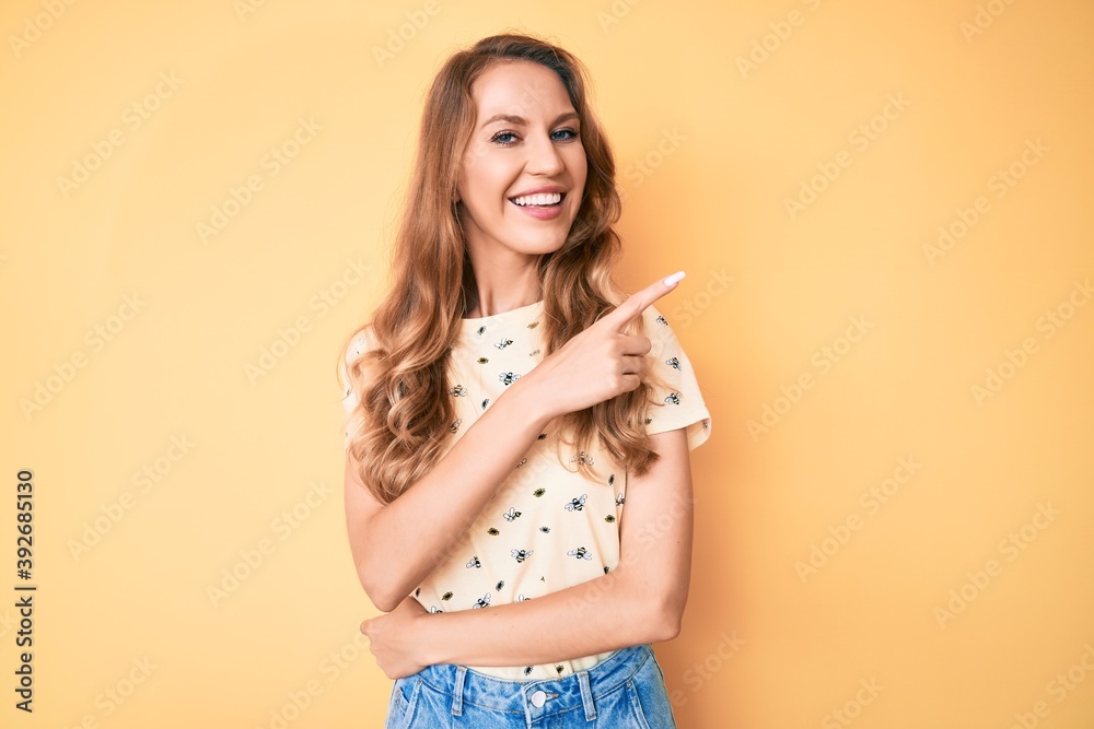 Young caucasian woman with blond hair wearing casual summer clothes smiling cheerful pointing with hand and finger up to the side Young caucasian woman with blond hair wearing casual summer clothes smiling cheerful pointing with hand and finger up to the side