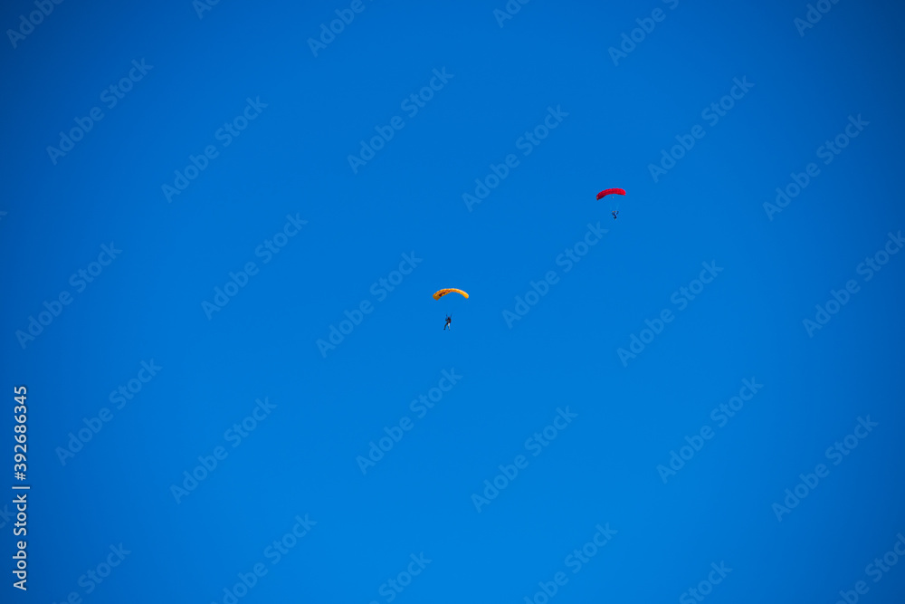 Parachutist on the background of blue sky