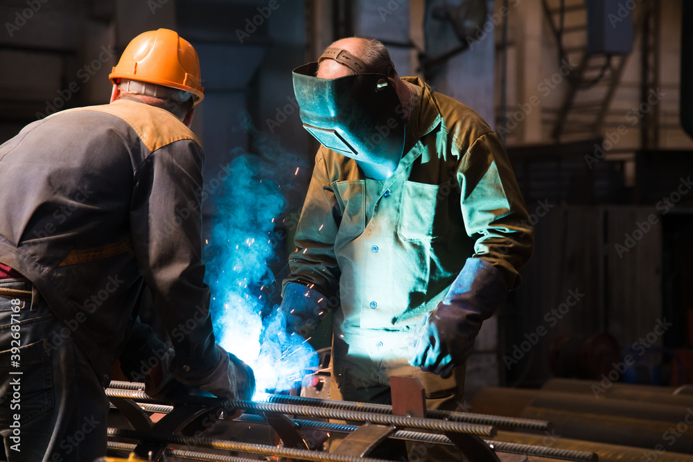 Welders working at the factory made metal Welders working at the factory made metal