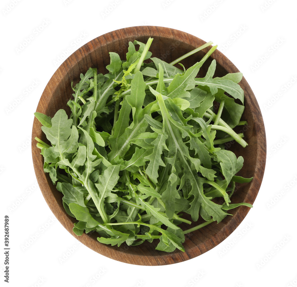 Delicious fresh arugula in wooden bowl isolated on white, top view Delicious fresh arugula in wooden bowl isolated on white, top view