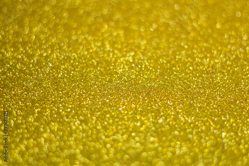 Universal celebration background,  perfect for Christmas or New Year, yellow glitter, selective focus