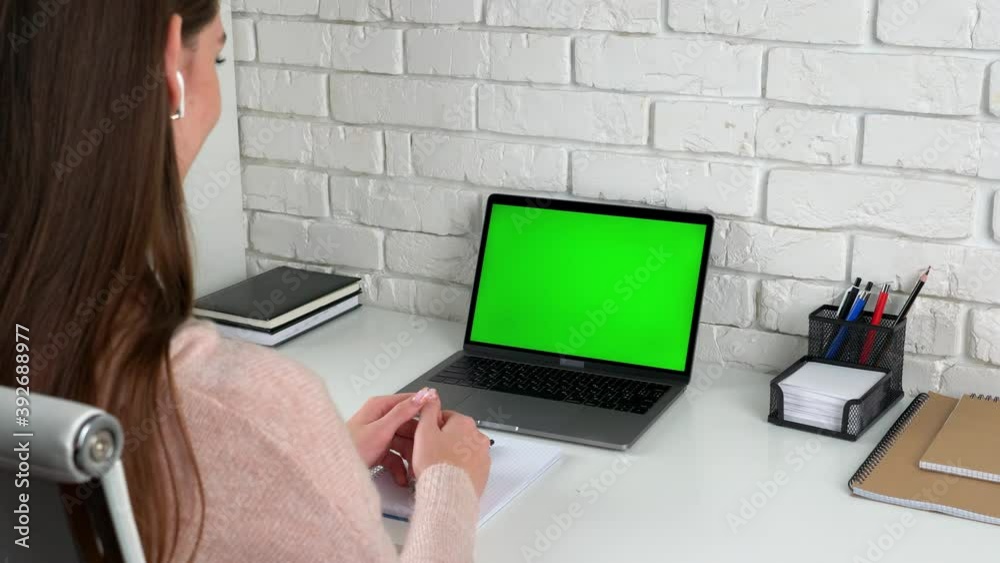 Green screen laptop computer concept: online remote distance learning education by webcam video call conference. Smart woman student at home office sits table study greets listen talk teacher tutor Green screen laptop computer concept: online remote distance learning education by webcam video call conference. Smart woman student at home office sits table study greets listen talk teacher tutor