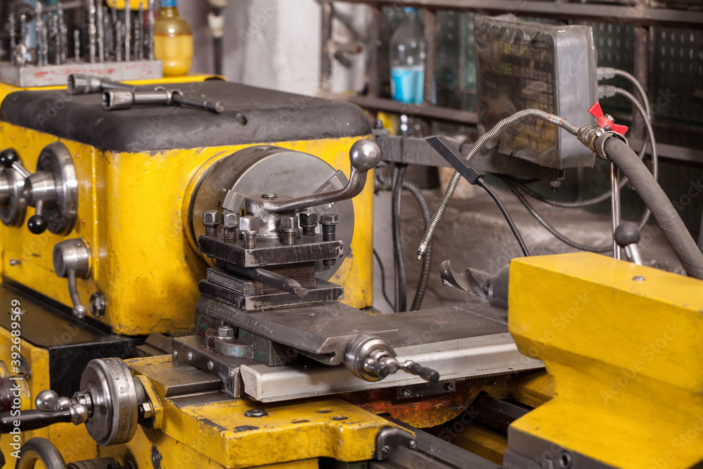 Old yellow lathe machine with a lot of handles. Old yellow lathe machine with a lot of handles.