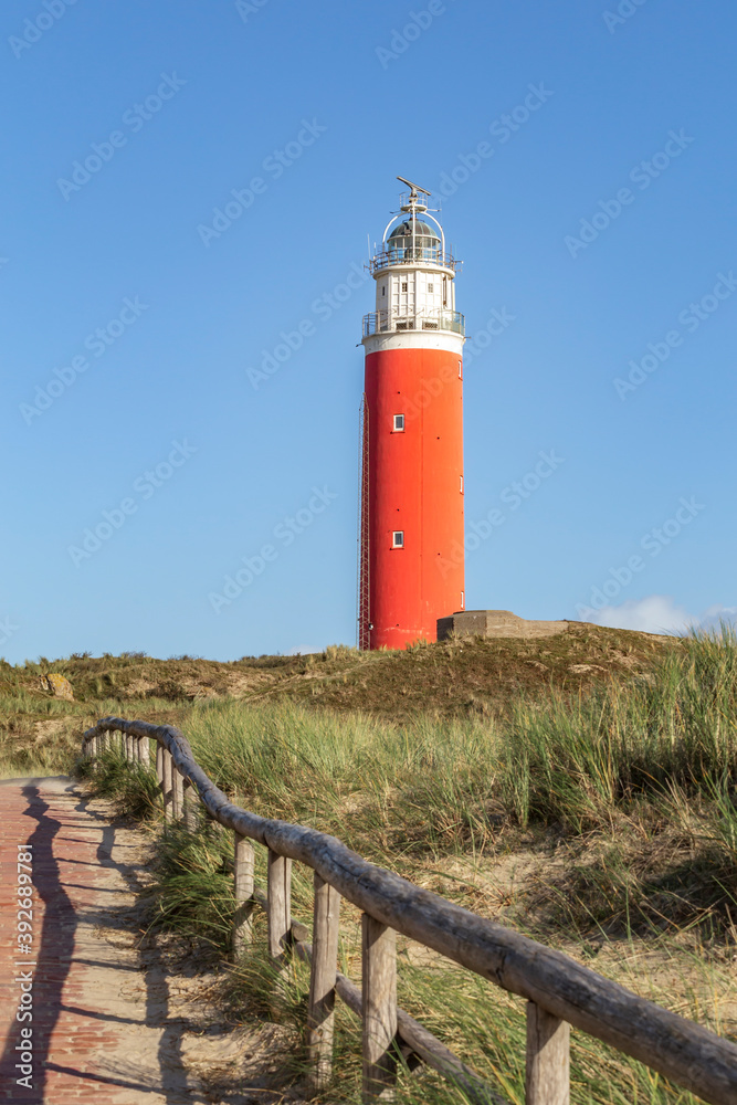 Vertical landscape with Lighthouse in front of a blue sky at Waddenisland Texel, North Holland, Netherlands