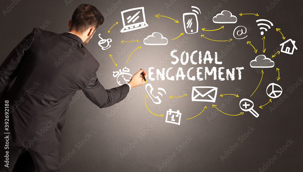 businessman drawing social media icons with SOCIAL ENGAGEMENT inscription, new media concept businessman drawing social media icons with SOCIAL ENGAGEMENT inscription, new media concept