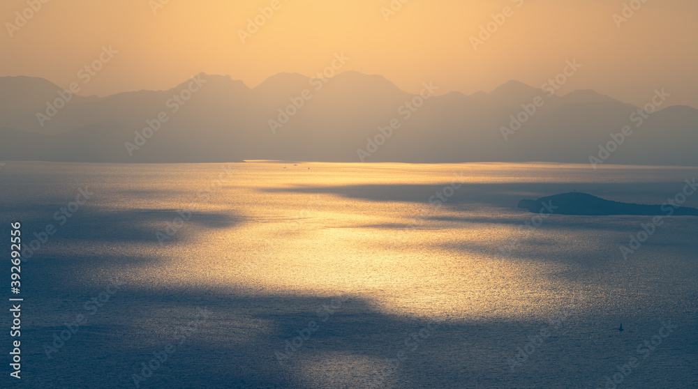 Majestic play of light and shadow shaped from the setting sun on the rippled surface of the mediterranean sea. Moody and atmospheric seascape Majestic play of light and shadow shaped from the setting sun on the rippled surface of the mediterranean sea. Moody and atmospheric seascape