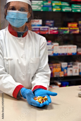 Pharmacist dispensing drugs in a pharmacy.