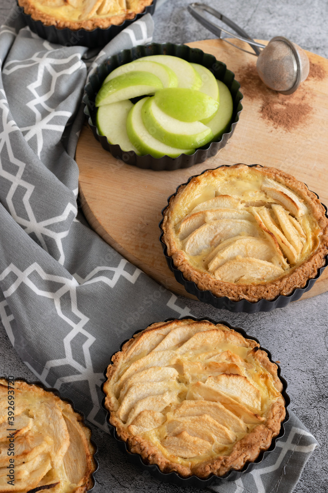 Ready to eat apple pies on grey background