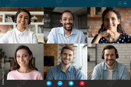 Computer screen web camera view happy multiracial millennial friends or colleagues communicating distantly, chatting in group conference video call from home or enjoying online training seminar.