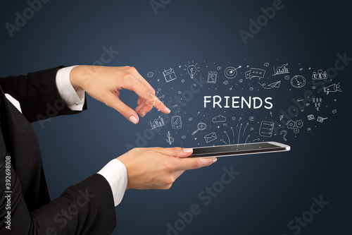 Close-up of a touchscreen with FRIENDS inscription, social media concept