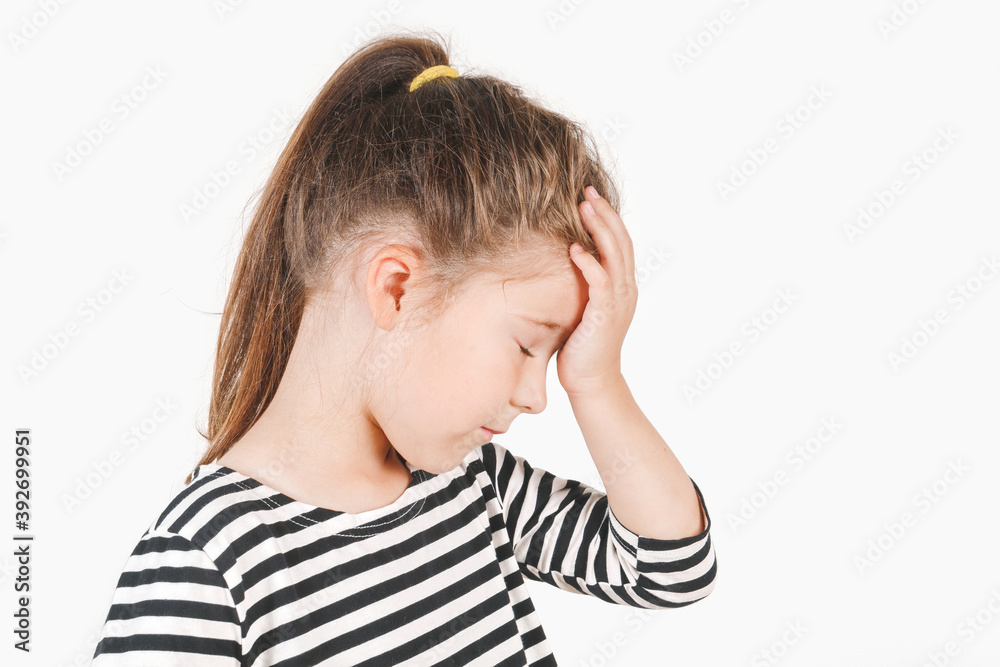 Facepalm. Upset girl with closed eyes and hand holding on her forehead. Frustrated forgetful girl with head tilted forward down. Posing a little girl wearing a striped shirt. Isolated white background Facepalm. Upset girl with closed eyes and hand holding on her forehead. Frustrated forgetful girl with head tilted forward down. Posing a little girl wearing a striped shirt. Isolated white background