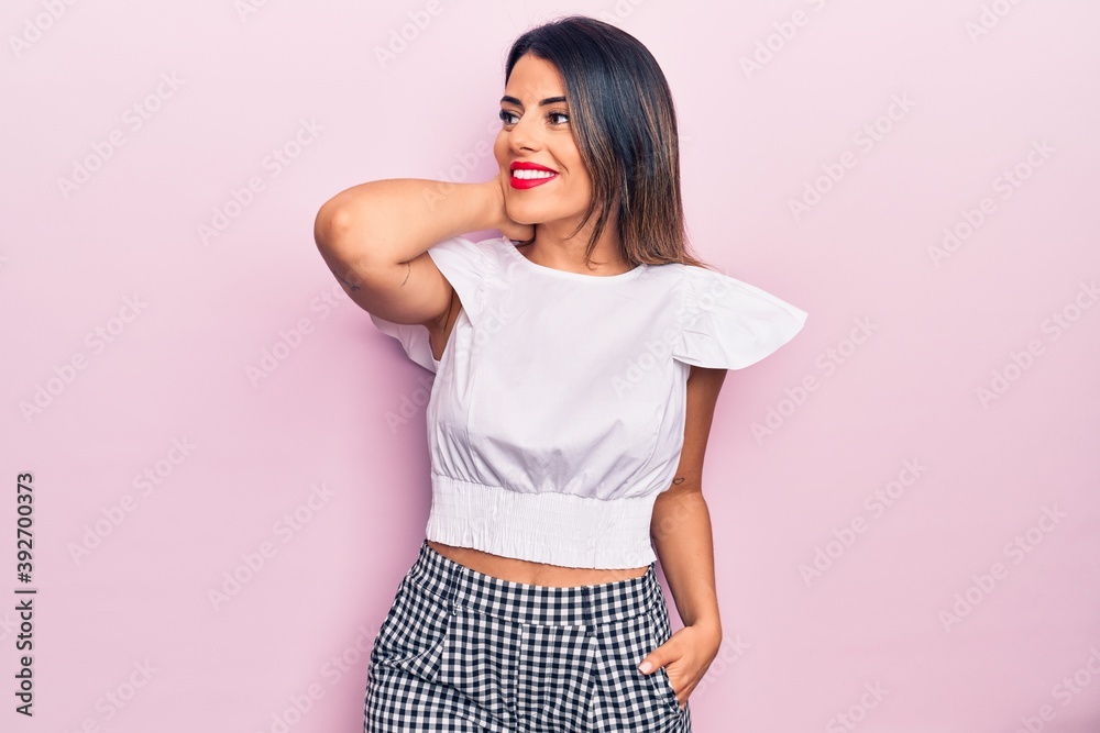 Young beautiful brunette woman wearing casual clothes smiling happy and confident. Standing with smile on face over isolated pink background Young beautiful brunette woman wearing casual clothes smiling happy and confident. Standing with smile on face over isolated pink background