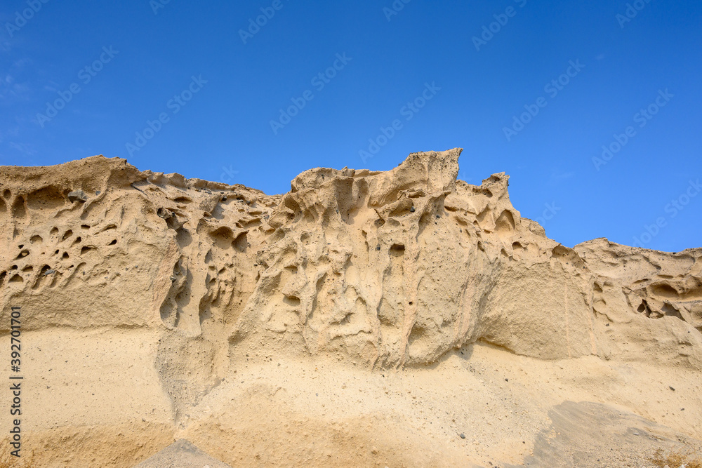 Bright cliffs formed by a volcano at Vlychada Beach, also known as the Moon Beach. Southern part of Santorini Island. Cyclades, Greece