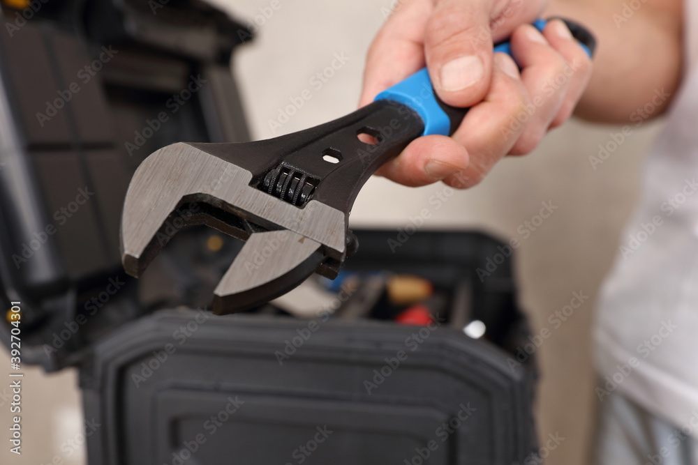 Craft man holding wrench tool close up. Craft man holding wrench tool close up.