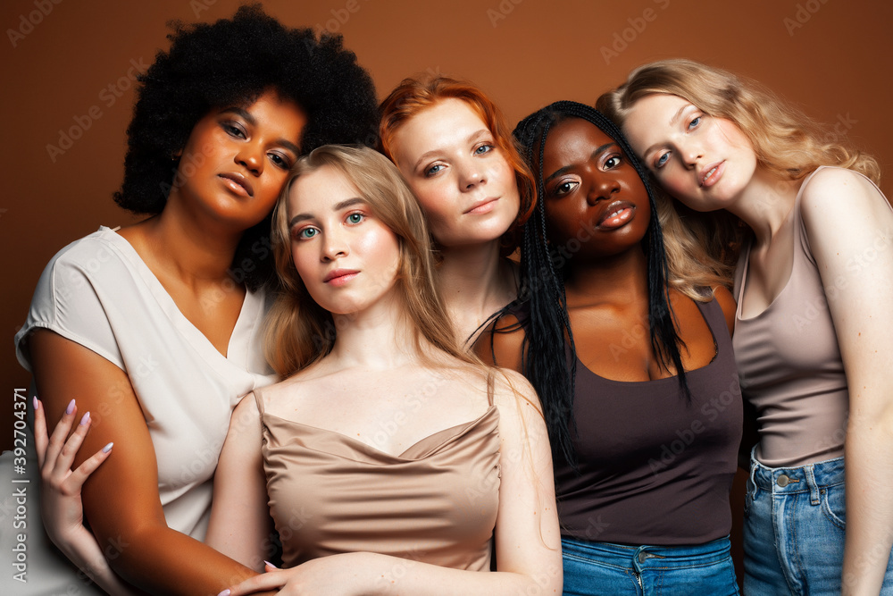 young pretty caucasian, afro, scandinavian woman posing cheerful together on brown background, lifestyle diverse nationality people concept young pretty caucasian, afro, scandinavian woman posing cheerful together on brown background, lifestyle diverse nationality people concept
