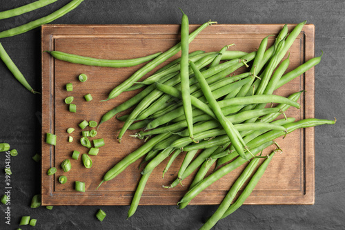 Fresh green beans on black table, flat lay