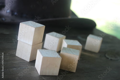 Light Wooden toy blocks on dark wooden background