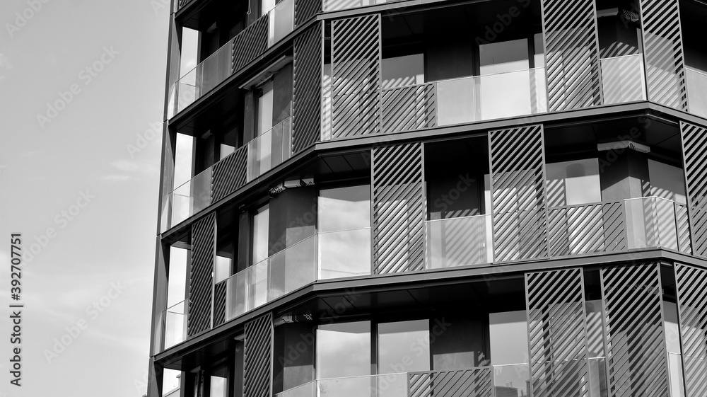 Fototapeta premium Detail of modern residential flat apartment building exterior. Fragment of new luxury house and home complex. Black and white.