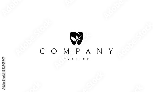 Vector black logo on which an abstract image of a tooth with a silhouette of a plant inside.