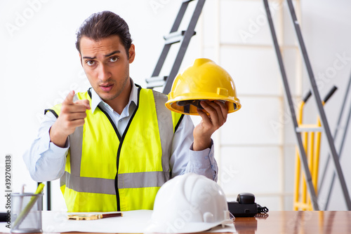 Young male architect working indoors