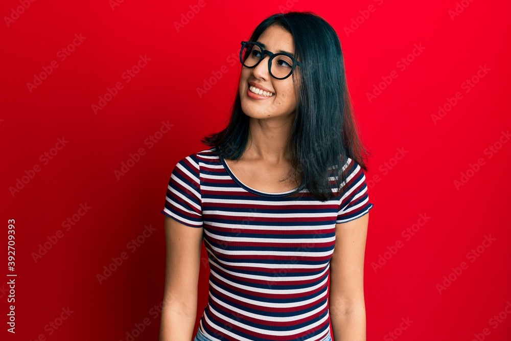 Fototapeta premium Beautiful asian young woman wearing casual clothes and glasses looking to side, relax profile pose with natural face and confident smile.