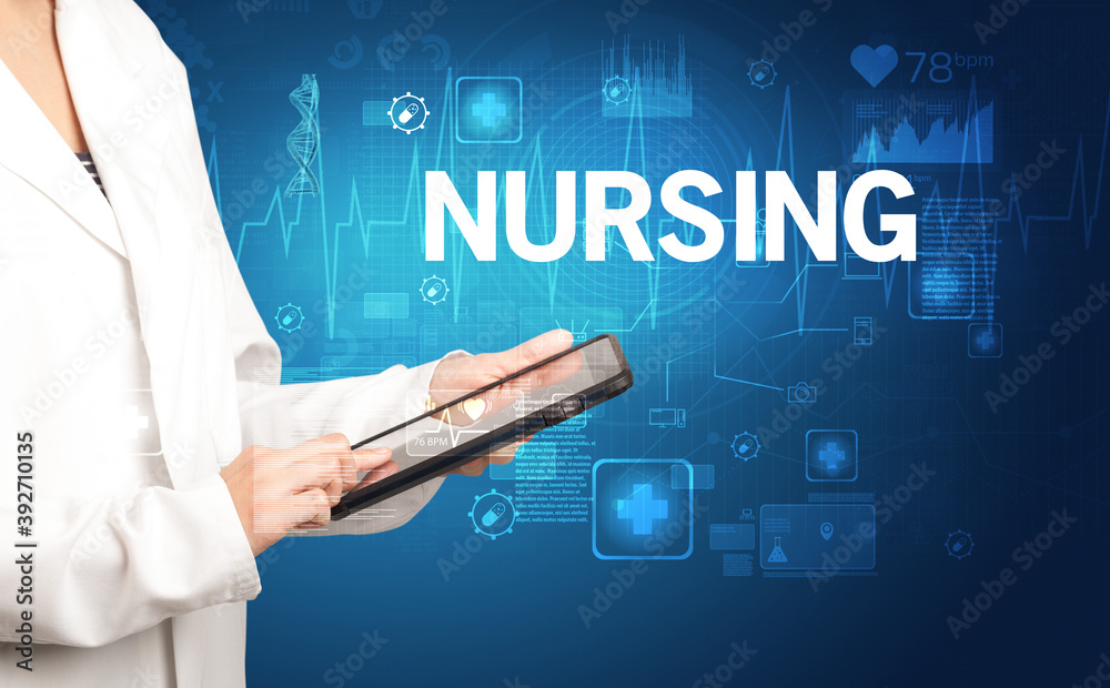 young doctor writing down notes with NURSING inscription, healthcare concept young doctor writing down notes with NURSING inscription, healthcare concept