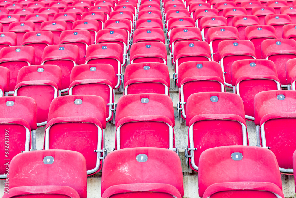 Naklejka premium empty red chairs in the outdoor arena