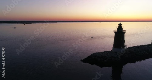 Sunrise over the Delaware Bay with a Lighthouse, off the coast of Cape May, aerial drone shot
