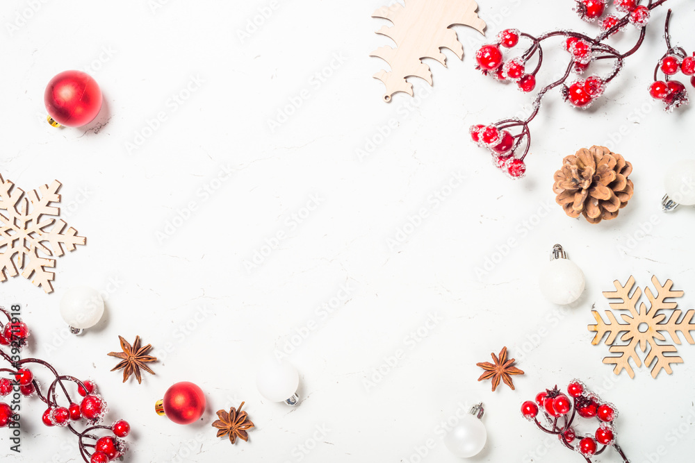 Christmas composition with red decorations at white table.