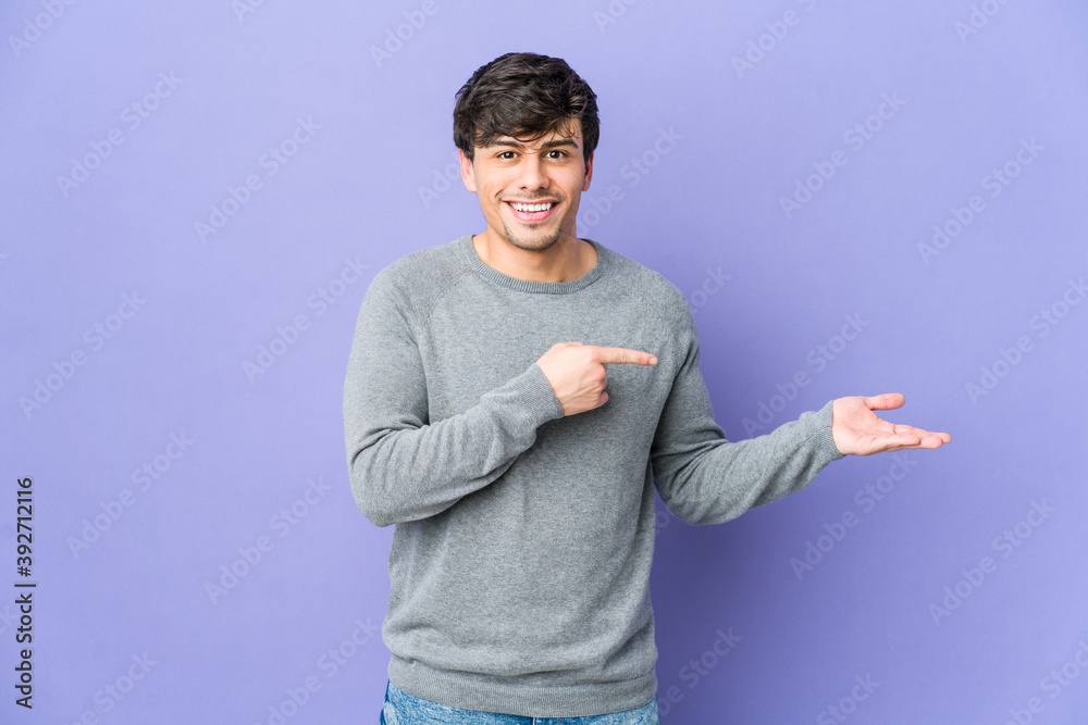 Young cool man excited holding a copy space on palm. Young cool man excited holding a copy space on palm.