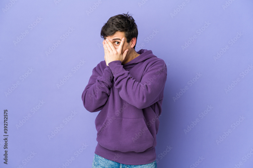 Young cool man blink through fingers frightened and nervous. Young cool man blink through fingers frightened and nervous.