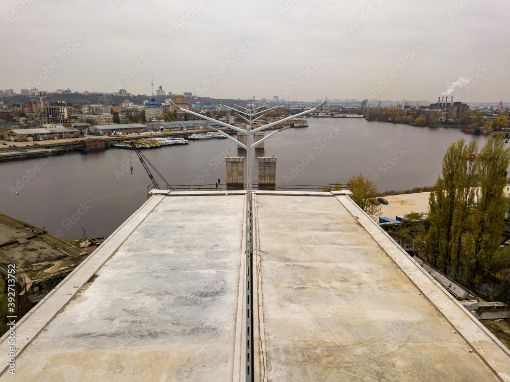 Aerial drone view. The edge of an unfinished bridge in Kiev. Cloudy autumn morning.