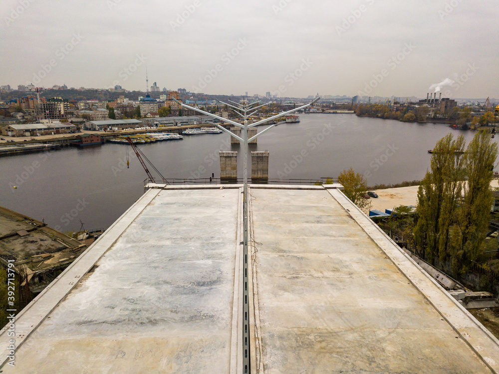 Aerial drone view. The edge of an unfinished bridge in Kiev. Cloudy autumn morning.