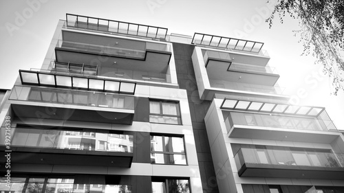 Detail of modern residential flat apartment building exterior. Fragment of new luxury house and home complex. Black and white.